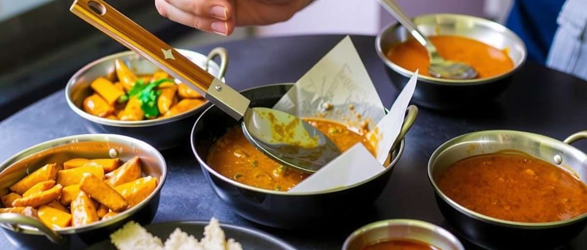 Curry Adventure featuring traditional cooking utensils and methods